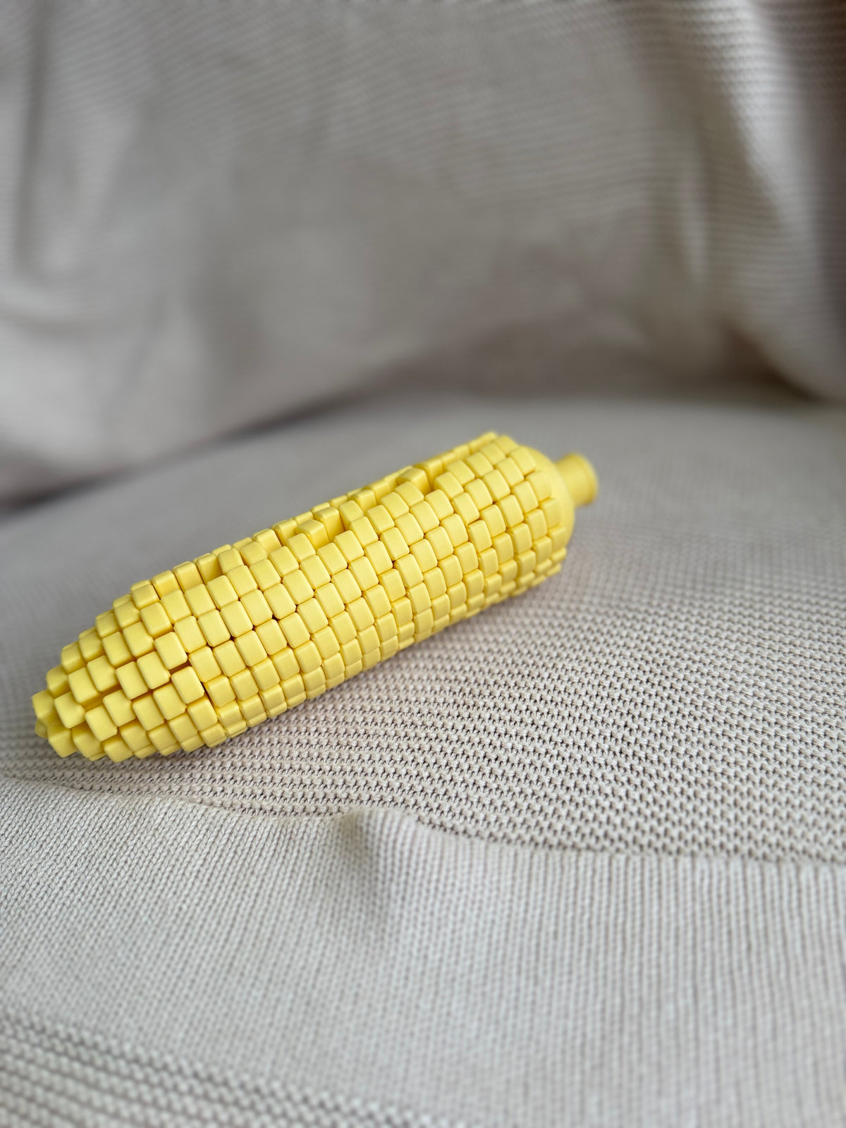 Yellow Twisty Corn lying on textured fabric