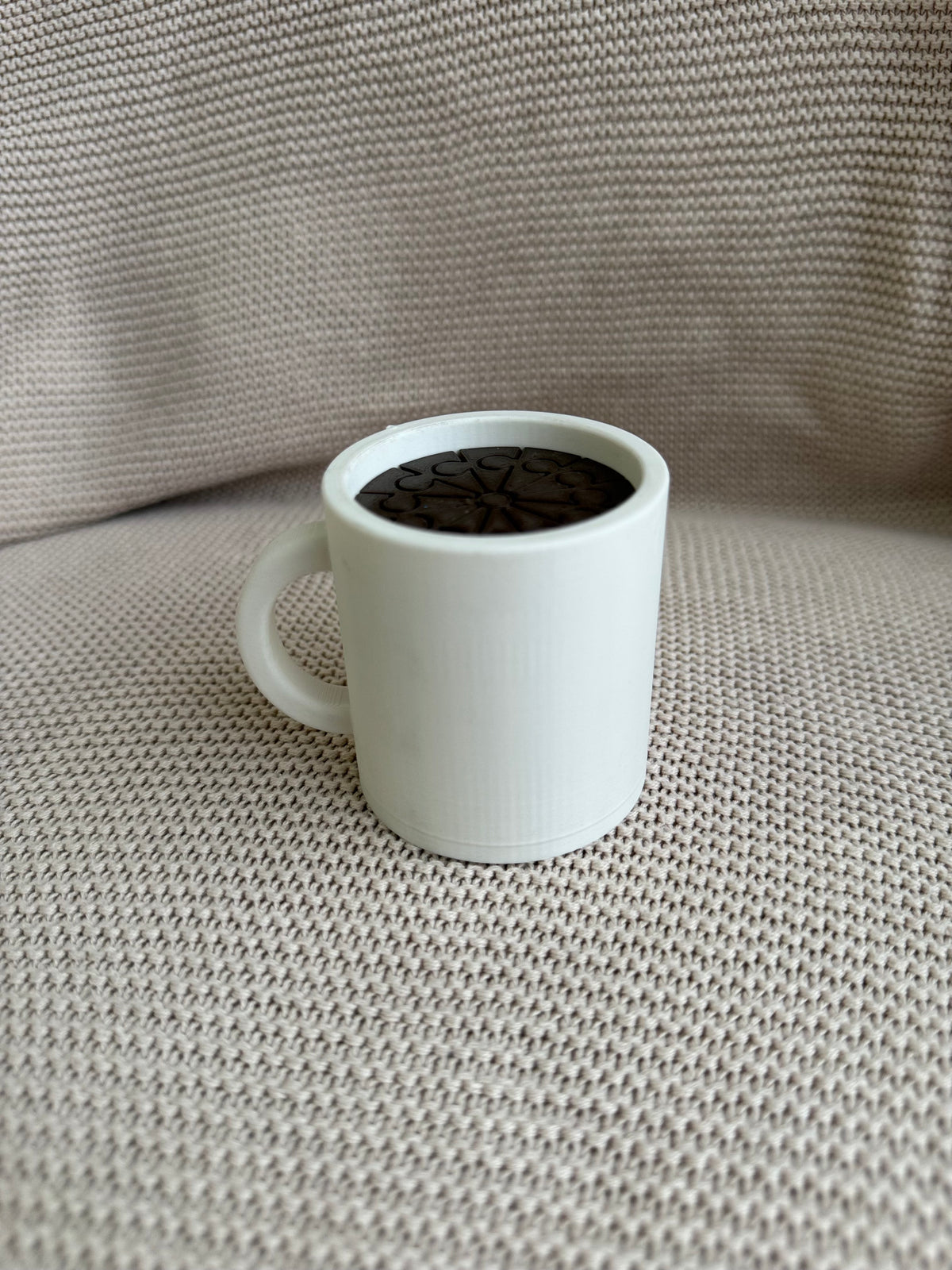 White pretend-play coffee cup with dark articulated coffee inside